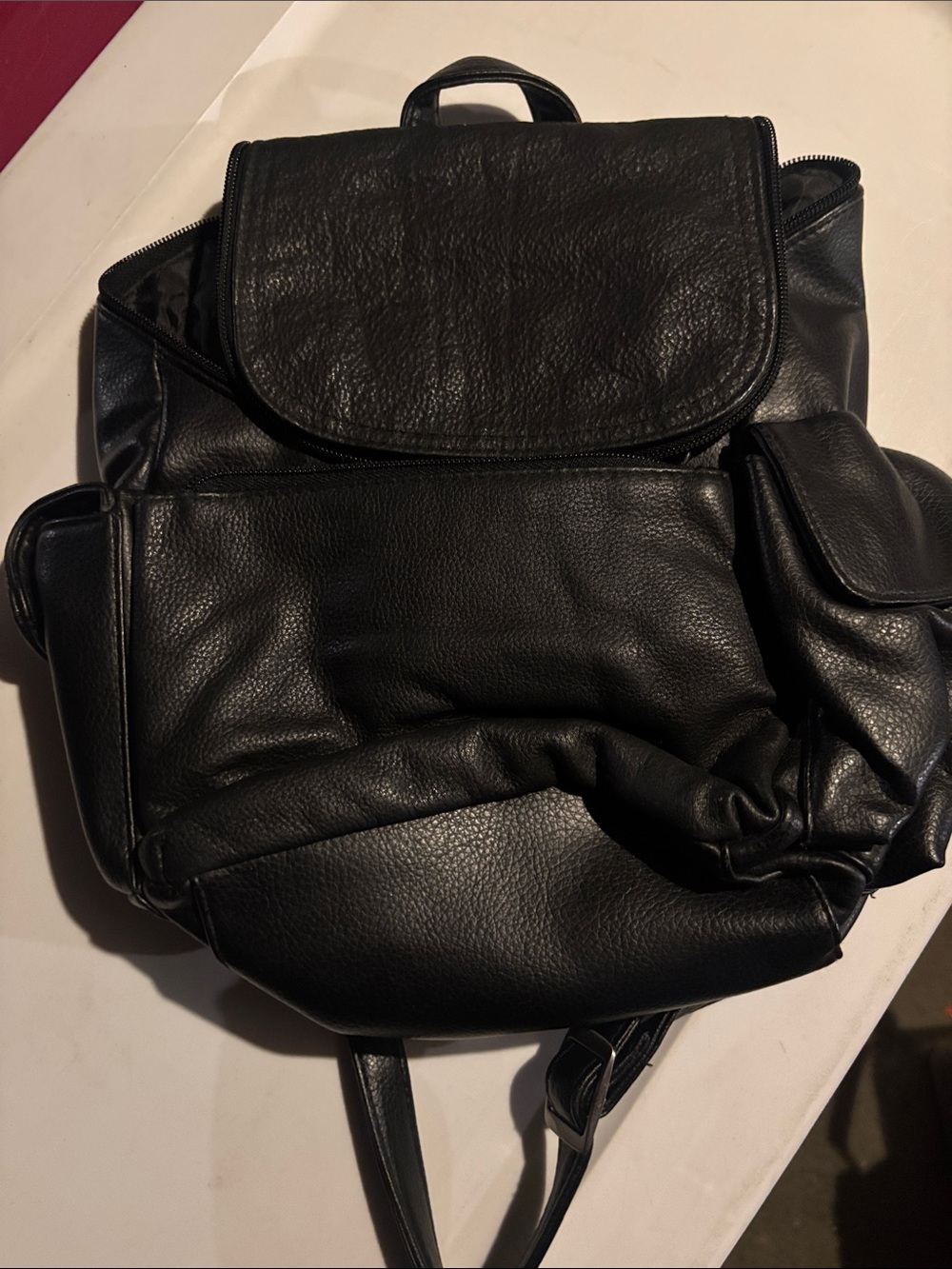 Black genuine Leather Backpack with manmade trim with pockets & card holder .